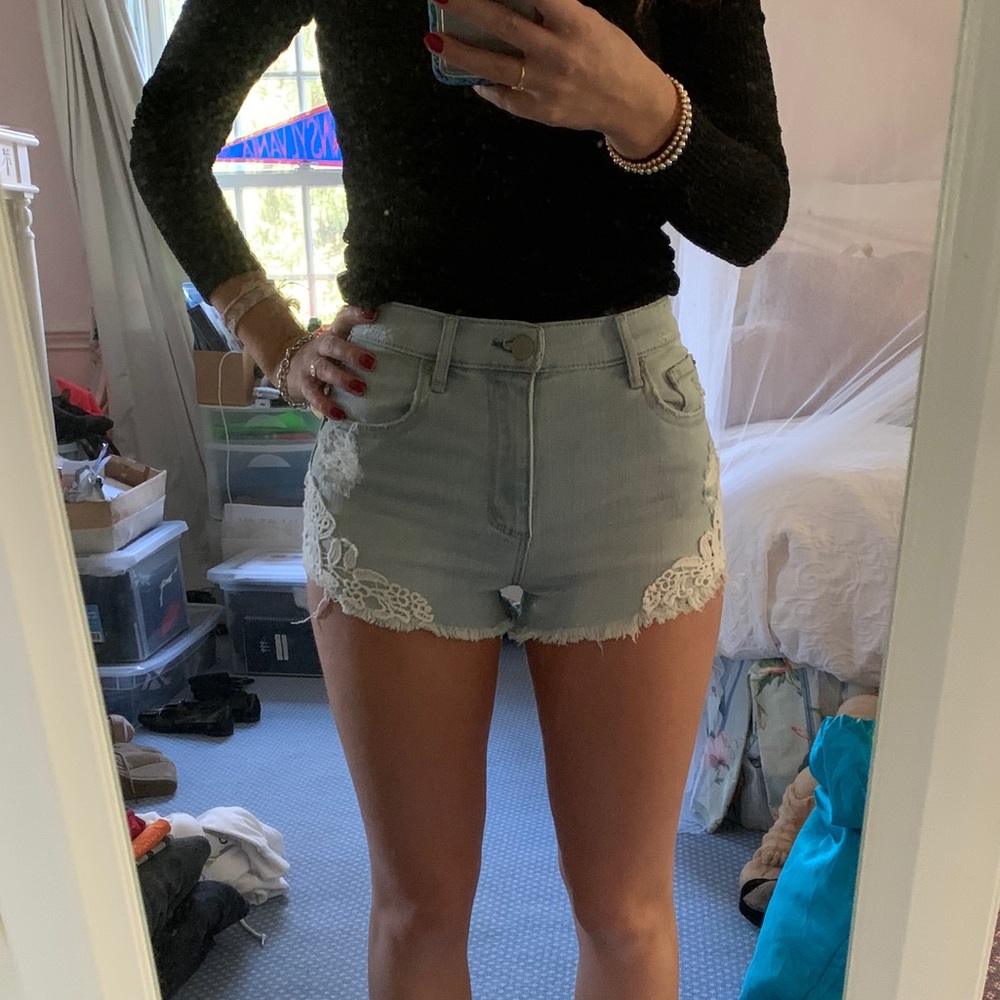 GARAGE light wash jean shorts with white lace trim